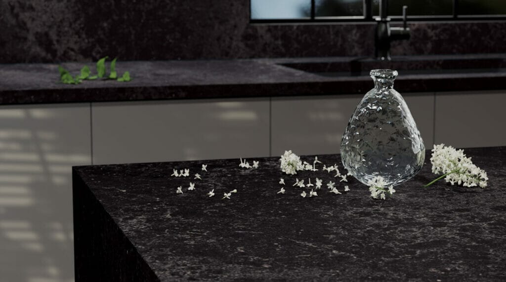 Black quartz kitchen countertop with vase and flowers 